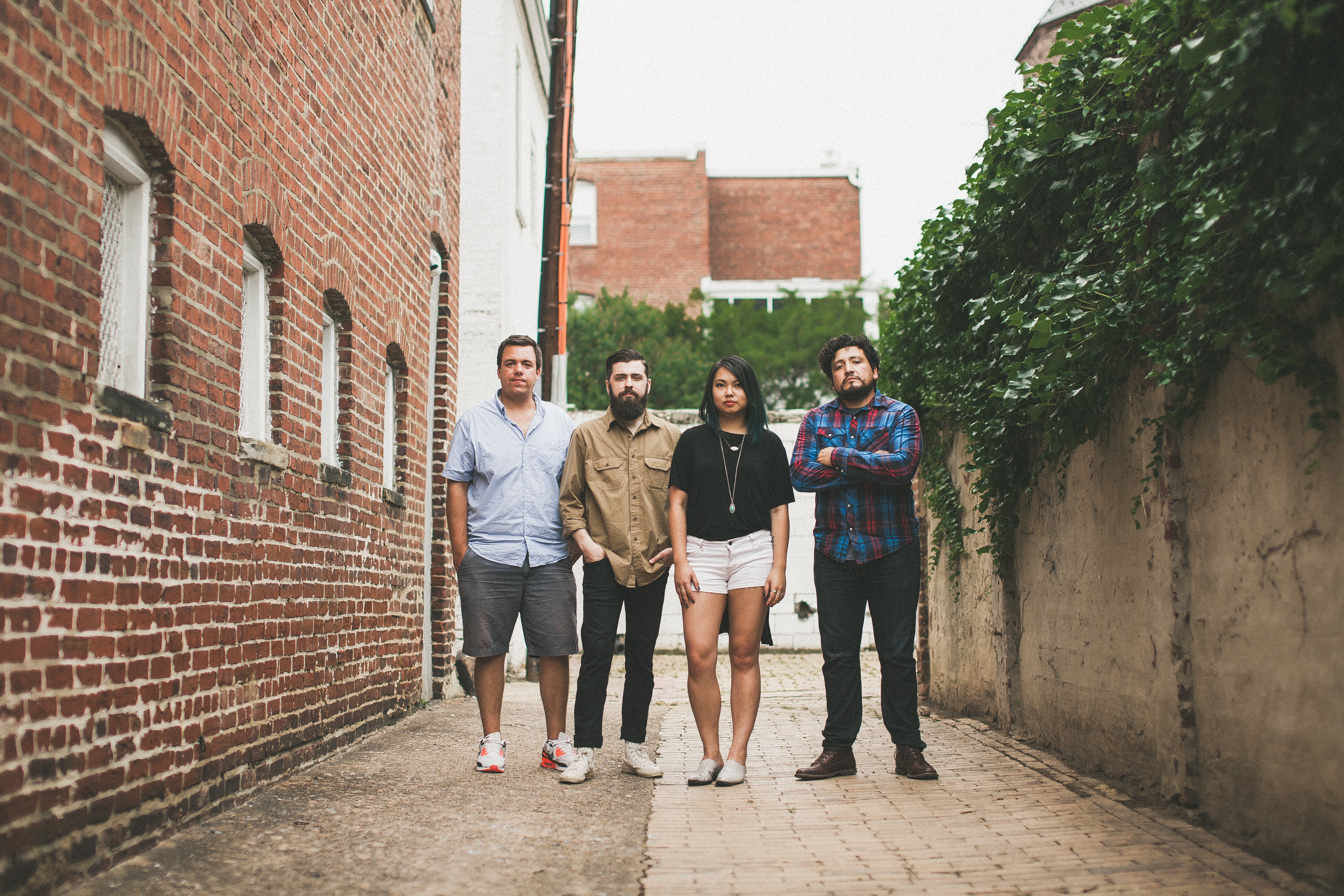 The 2016 Workhorse team, four members, standing in the brick alley behind the carriage house.